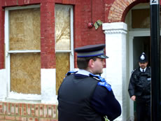 Police exiting Milton Road house