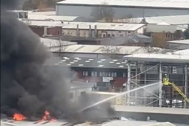 Firefighters use hoses at the industrial estate fire